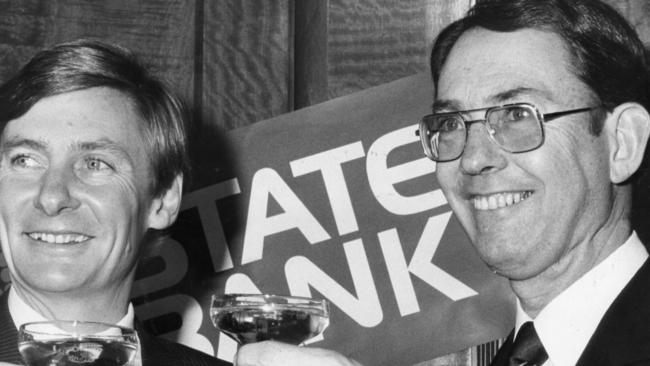 SA Premier John Bannon opens the new State Bank of South Australia, 02 Jul 1984. A champagne to toast the new bank's success with the managing director Tim Marcus Clark.