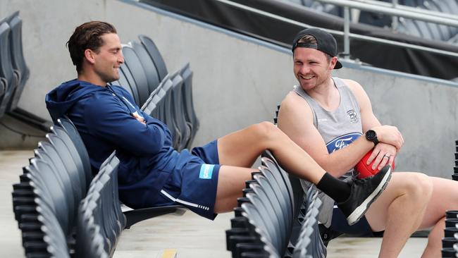 Patrick Dangerfield (right) watches the Cats train with teammate Luke Dahlhaus at GMHBA Stadium last week. Picture: Michael Klein