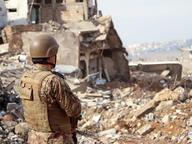 A Lebanese soldier looks on in the southern Lebanese village of Khiam after the withdrawal of Israeli forces from the area under a ceasefire deal with Hezbollah. Picture: AFP