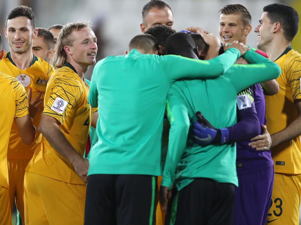 The Socceroos engulf Mat Ryan after the penalty shootout win over Uzbekistan. Francois Nel/Getty Images