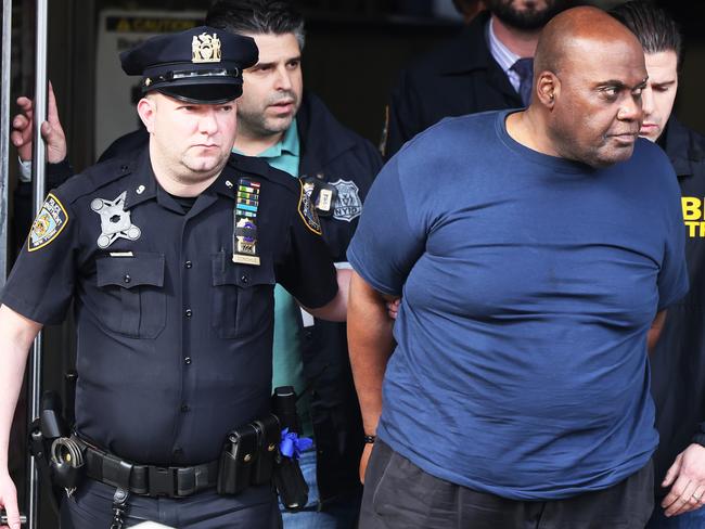 NEW YORK, NEW YORK - APRIL 13: Suspect Frank James is led by police from Ninth Precinct after being arrested for his connection to the mass shooting at the 36th St subway station on April 13, 2022 in New York City. James, the suspected gunman in Tuesday's shooting, was arrested this afternoon after a hotline caller's tip. James is alleged to have shot 10 people, critically injuring five, on the N train during Tuesday's morning rush hour.   Michael M. Santiago/Getty Images/AFP == FOR NEWSPAPERS, INTERNET, TELCOS & TELEVISION USE ONLY ==