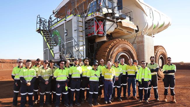 Dr Forrest stands in front of a new green energy haul truck and the Christmas Creek mine in WA’s Pilbara region. Picture: Rohan Kelly