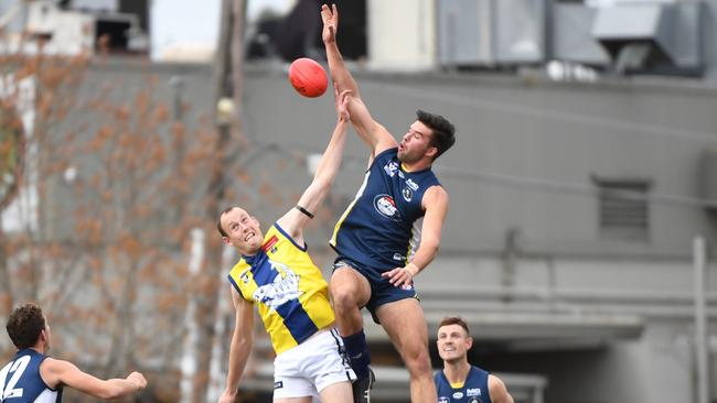 Jordan Perry leaps over Dylan Jones in last year’s Community Championships clash.