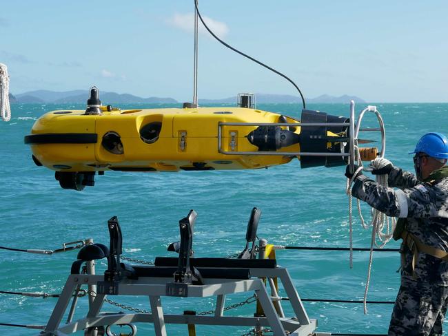 Royal Australian Navy sailors from mine hunter HMAS Huon conduct search operations in the vicinity of Lindeman Island, Queensland, 30 July 2023 following an Australian Army MRH-90 Taipan helicopter crash.