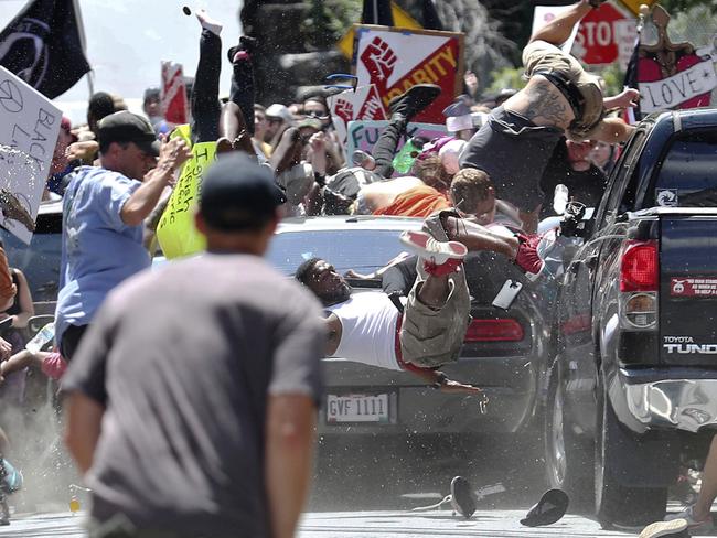 People fly into the air as a vehicle drives into a group of protesters demonstrating against a white nationalist rally in Charlottesville. Picture: AP