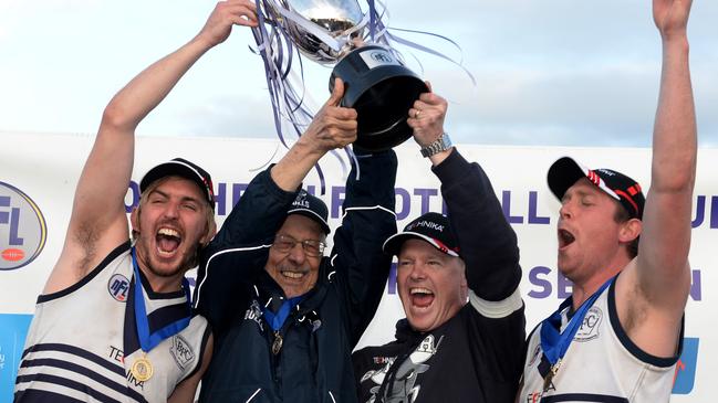 Bundoora captains and coaches lift the premiership trophy. Picture: Kris Reichl