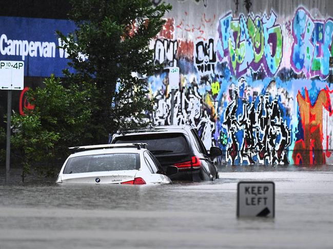 Flooding in Longland St, East Brisbane, on Sunday. Picture: John Gass