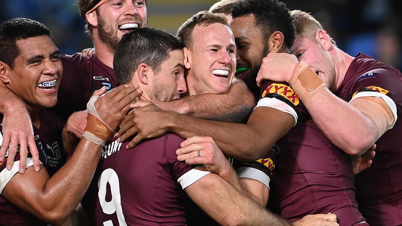 Ben Hunt of the Maroons celebrates with teammates after scoring his second try.