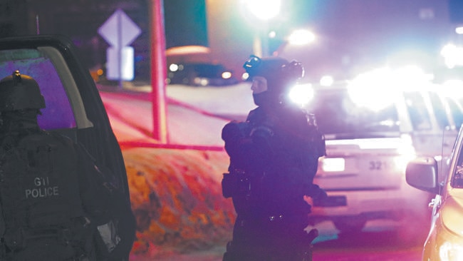 Police survey the scene after a deadly shooting at a mosque in Quebec City, Canada. Picture: Francis Vachon / The Canadian Press via AP