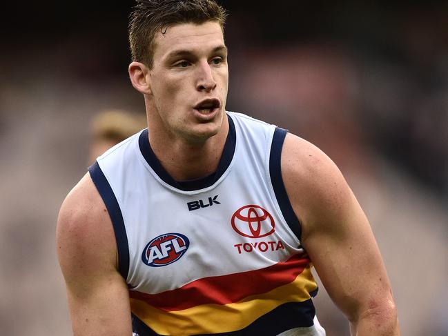 Josh Jenkins of the Crows handballs during the Round 15 AFL match between the Melbourne Demons and the Adelaide Crows at the MCG in Melbourne, Sunday, July 3, 2016. (AAP Image/Julian Smith) NO ARCHIVING, EDITORIAL USE ONLY