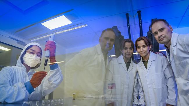 Research chemist Selina Chang with the nanoparticles inside the lab while UniSA senior research chemist Valentina Milanova and Professor Benjamin Thierry look on. Pic: Roy VanDerVegt