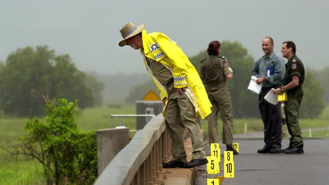 Police on the Adelaide River bridge investigating the scene near where the bodies of two prostitutes were found. PICTURE: Michael Marschall.