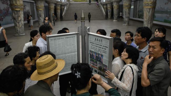 Commuters in Pyongyang yesterday read about the summit in the latest edition of the state-run Rodong Sinmun newspaper. Picture: AFP