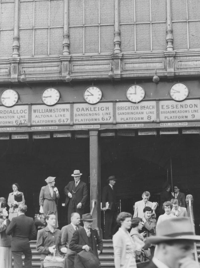 People on the station steps, under the railway line signs, in 1952.