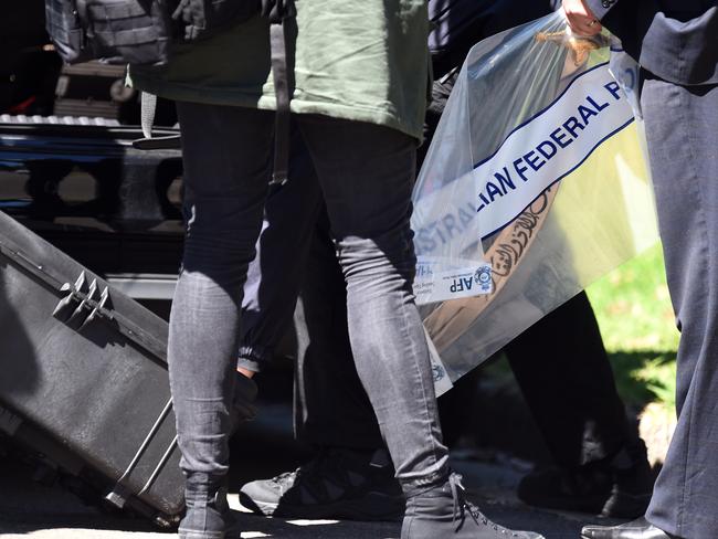Police remove a sword found at a home in Marsfield yesterday. Picture: AAP Image/Paul Miller.