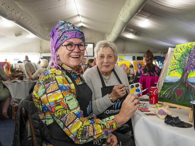 Trish Hedge (left) and Jan Rollo participate in the World's Largest Paint and Sip Luncheon for Momentum Mental Health at Clifford Park racecourse, Friday, June 21, 2024. Picture: Kevin Farmer
