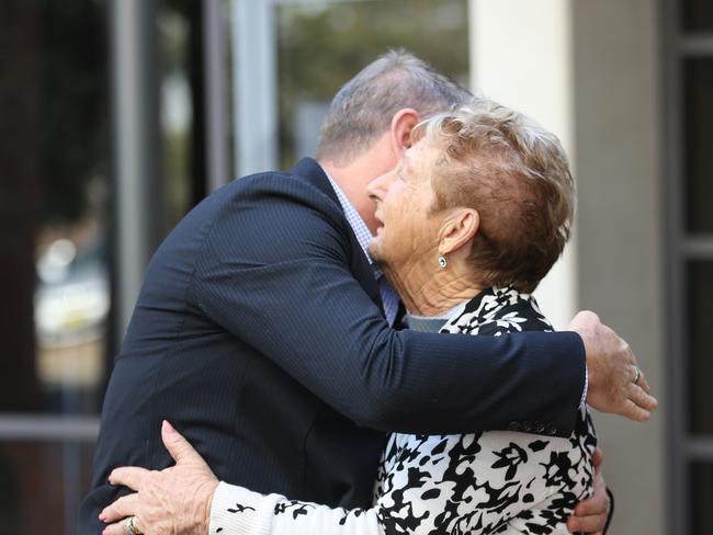 Steve Sibraa and Marion Smith comfort each other outside court after Valentine was sentenced. Picture: John Grainger