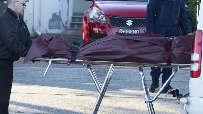 The body of Gilbert Caetano is removed from the property in Brighton-Le-Sands. Picture: Jenny Evans