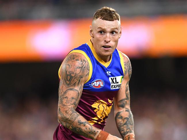 BRISBANE, AUSTRALIA - APRIL 14: Mitch Robinson of the Lions handles the ball during the round five AFL match between the Brisbane Lions and the Collingwood Magpies at The Gabba on April 14, 2022 in Brisbane, Australia. (Photo by Albert Perez/AFL Photos/Getty Images)