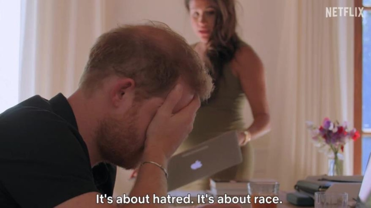 Prince Harry buries his head in his hands as a heavily pregnant Meghan Markle holds a laptop in a still from the new trailer. Picture: Netflix