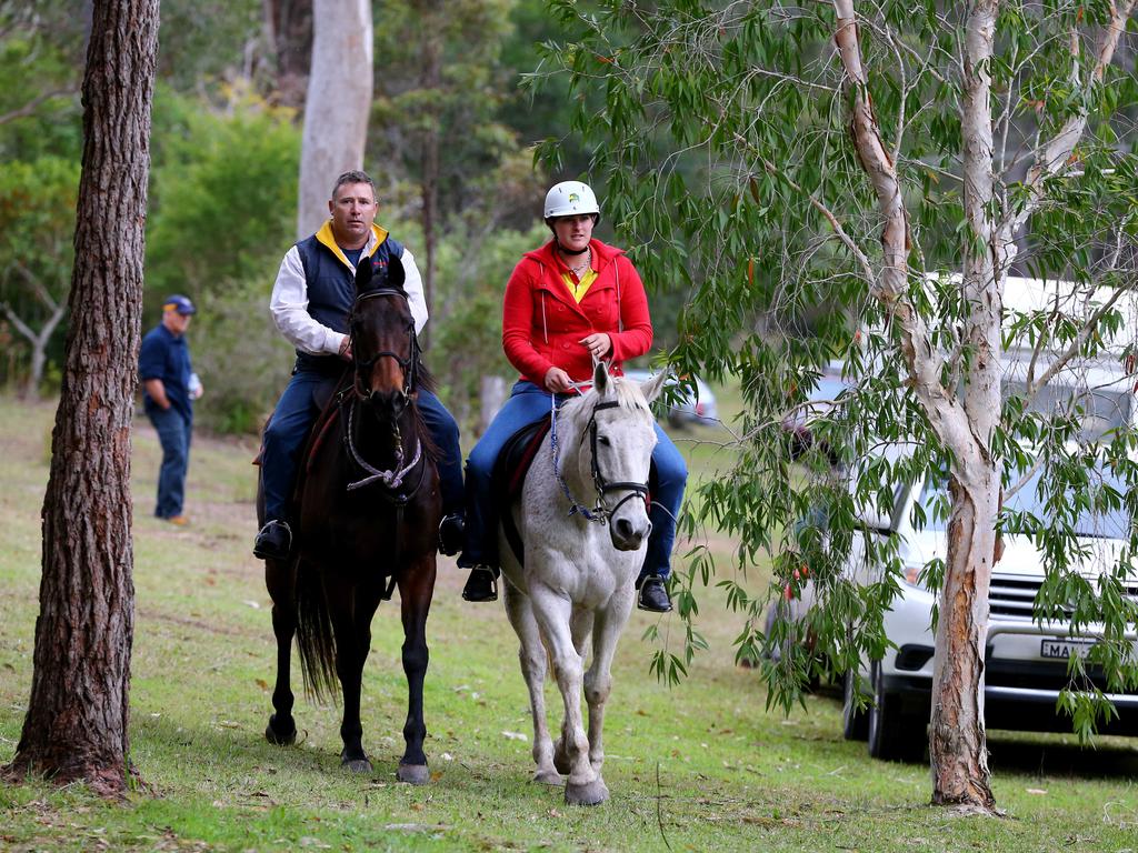 Volunteers on horseback in the search for the missing boy in bush near Benaroon Drive in Kendall.