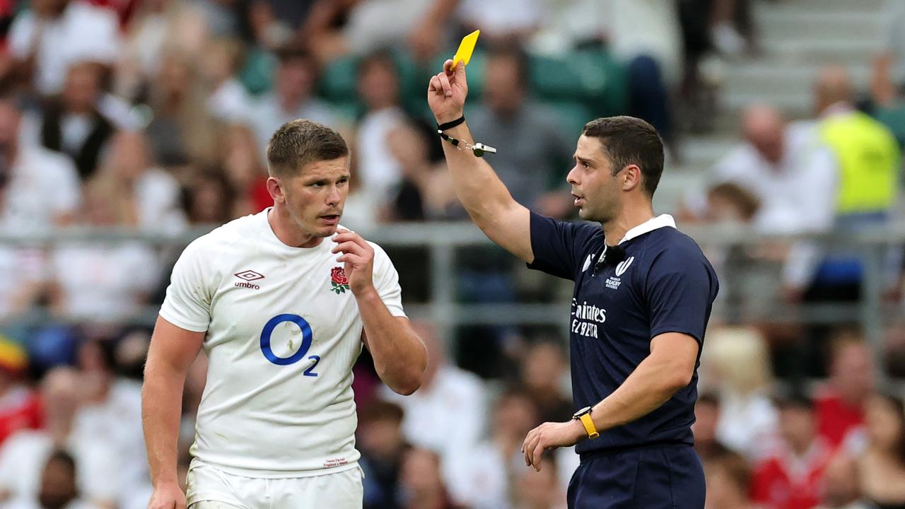 Nika Amashukeli, the referee, shows Owen Farrell, the England captain, a yellow card which was later upgraded to red after a TMO review. (Photo by David Rogers/Getty Images)