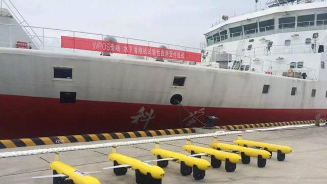 A selection of Haiyi, or sea-wing, drones alongside a Chinese survey ship. Picture: Chinese state media