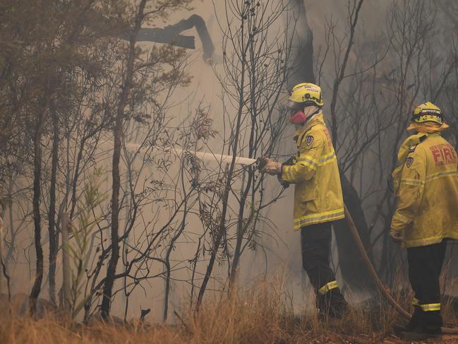 Fire fighters in action at the Gospers Mountain blaze north of Sydney .(AAP Image/Dean Lewins)