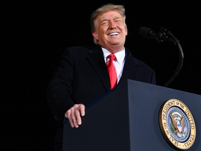 (FILES) In this file photo former US President Donald Trump speaks during a rally in support of Republican incumbent senators Kelly Loeffler and David Perdue ahead of Senate runoff in Dalton, Georgia on January 4, 2021. - Former US president Donald Trump will be allowed back on YouTube but only when the threat of his inciting violence abates, the head of the popular online video sharing platform said on March 4, 2021. (Photo by MANDEL NGAN / AFP)