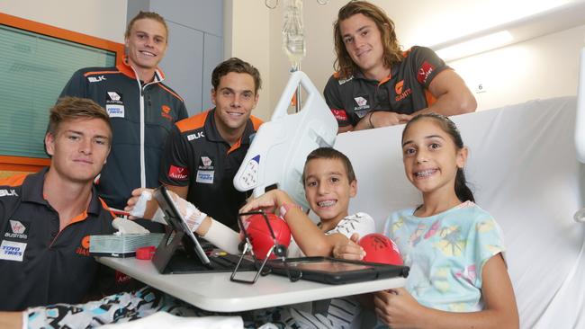 Tomlinson with former GWS teammates visit children at Campbelltown hospital.