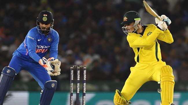 India wicket keeper Rishabh Pant (L) watches as Peter Handscomb (R) plays a shot. Picture: AFP. 