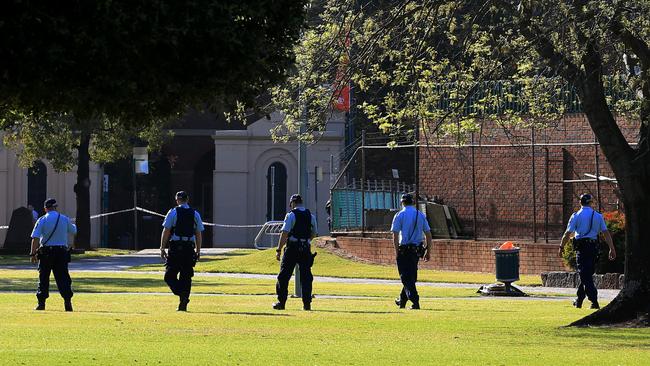 Police conduct a line search through Bigge Park after suspecting it is the site of the stabbings. Picture: Toby Zerna