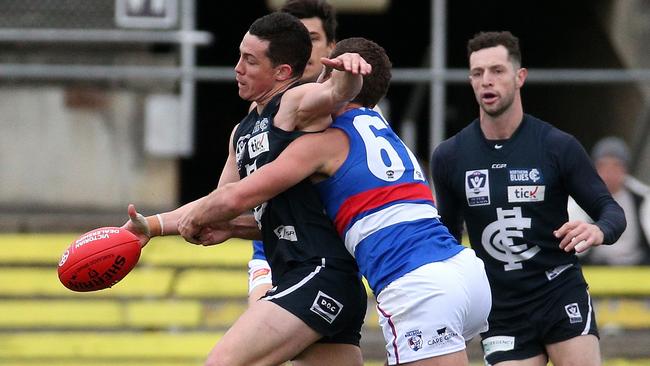 Tom Wilson of Northern is tackled by Lachlan Smith of Footscray during VFL footy: Northern Blues v Footscray on Saturday, June 30, 2018, in Carlton North, Victoria, Australia. Picture: Hamish Blair