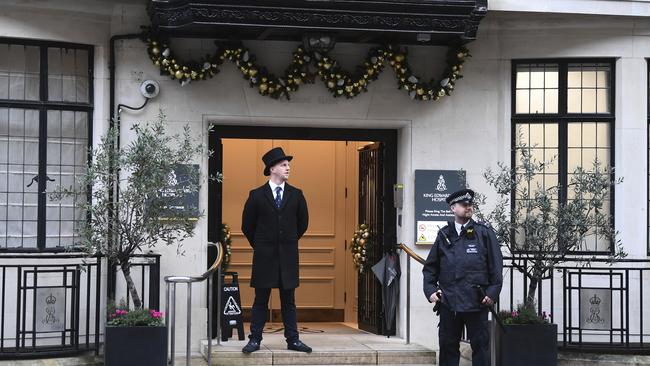 Police and hospital personnel outside King Edward VII's Hospital, in London, where Prince Philip is under care. Picture: AP