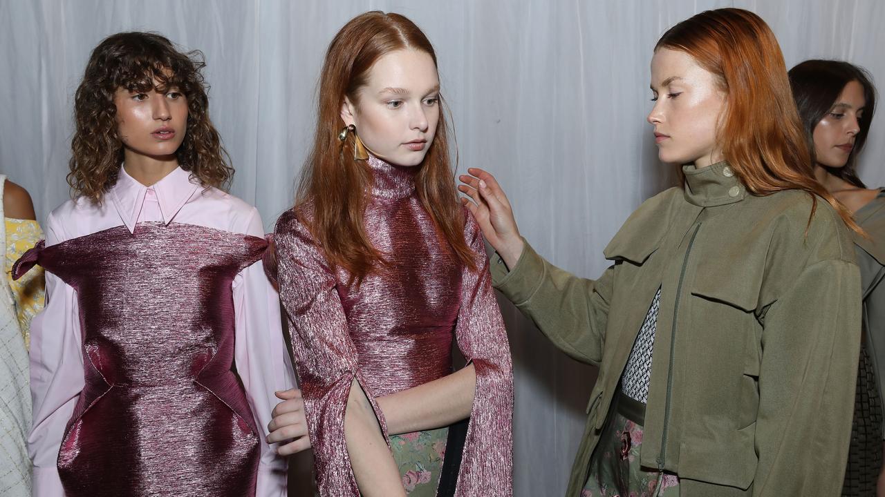 A model prepares backstage ahead of the Mercedes-Benz Presents Camilla And Marc show