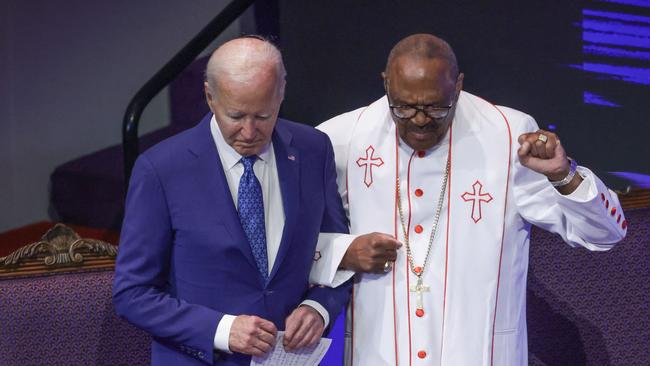 Joe Biden stands with Bishop Ernest Morris during a prayer at a campaign stop at Mt Airy Church of God in Christ in Philadelphia. Picture: Getty Images via AFP