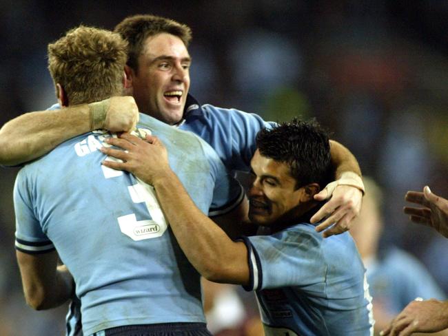 Brad Fittler celebrates a try with Mark Gasnier (left) and Craig Wing (right) during a 2004 State of Origin match.