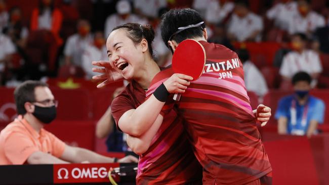 Ito Mima (L) and Jun Mizutani (R) of Team Japan embrace after winning their Mixed Doubles Gold Medal match. Picture: Getty Images