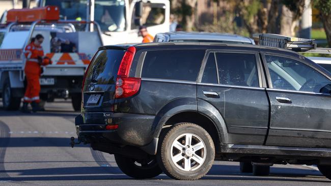 Police are also collecting evidence from a black SUV. Picture: Ian Currie