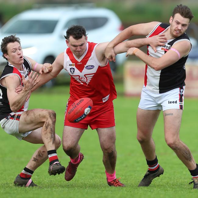 Alvie’s Dominic Dare battles with two Birregurra opponents Mitch Russell, left, and Kyle Davis. Pictures: Yuri Kouzmin