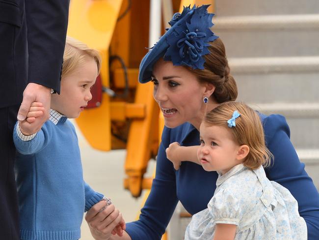 VICTORIA, BC - SEPTEMBER 24:  (L-R) Catherine, Duchess of Cambridge speaks to Prince George of Cambridge while holding Princess Charlotte of Cambridge as they arrive at Victoria International Airport on September 24, 2016 in Victoria, Canada.  (Photo by Dominic Lipinski-Pool/Getty Images)