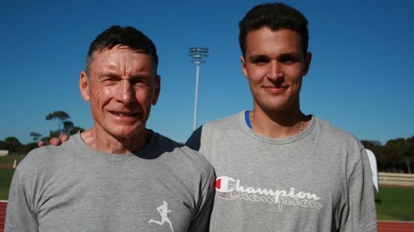 Murphy, right, alongside coach Peter Fitzgerald after running his record-breaking 200m. Picture: Supplied