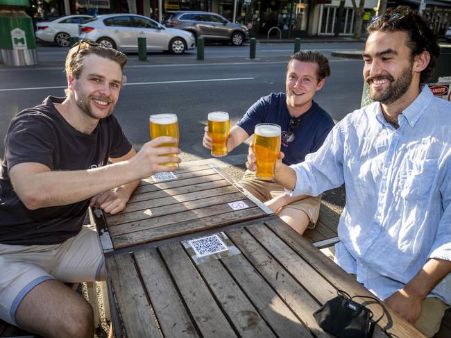 Generic pics of people dining out.  Melbourne cafe generic. Melbourne restaurant generic. Will Keenan, Callum McDermot and Fergus Morrison enjoy a beer on Lygon Street. Picture: Jake Nowakowski