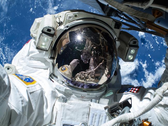 epa04636092 A handout picture made available by NASA on 25 February 2015 shows US NASA astronaut Barry Wilmore operating outside the International Space Station (ISS) on the first of three spacewalks preparing the station for future arrivals by US commercial crew spacecraft, in space, 21 February 2015. US spacewalker Terry Virts is seen reflected in Wilmore's visor. The spacewalks are designed to lay cables along the forward end of the US segment to bring power and communication to two International Docking Adapters slated to arrive later this year. The new docking ports will welcome US commercial spacecraft launching from Florida, USA, beginning in 2017, permitting the standard station crew size to grow from six to seven and potentially double the amount of crew time devoted to research. The second and third spacewalks are planned for 25 February 2015 and 01 March 2015, with Wilmore and Virts participating in all three. EPA/NASA HANDOUT EDITORIAL USE ONLY