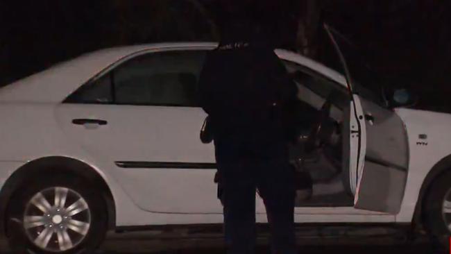 Police inspect the stolen car after it was dumped on nearby Kettering Rd. Picture: 7NEWS