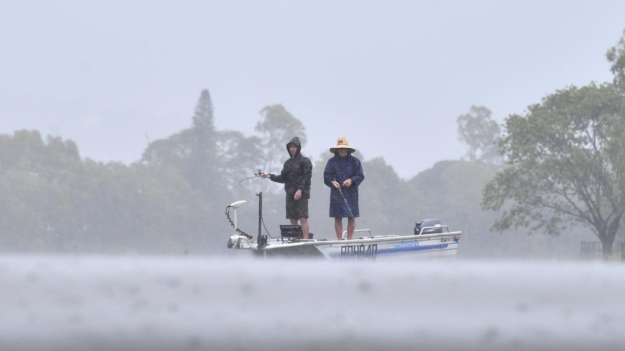 Heavy rain does not stop fishing at Applins Weir. Picture: Evan Morgan