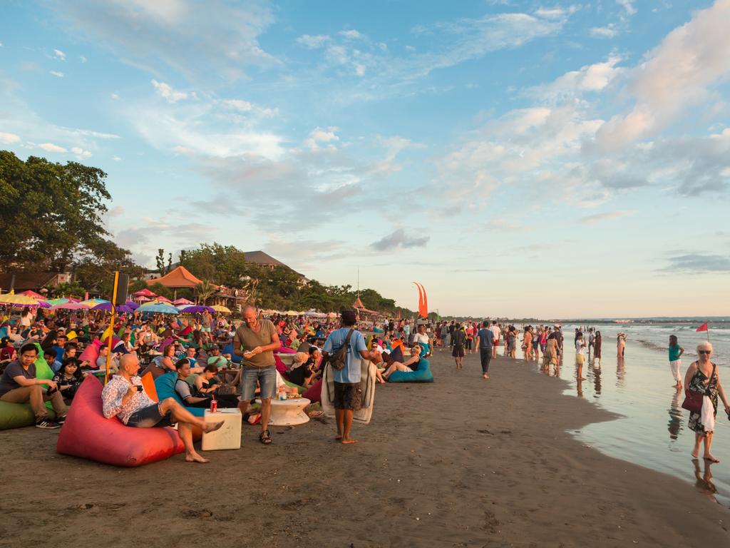 A large crowd of tourists at a beach bar on Kuta beach in Seminyak, Bali. Picture: iStock