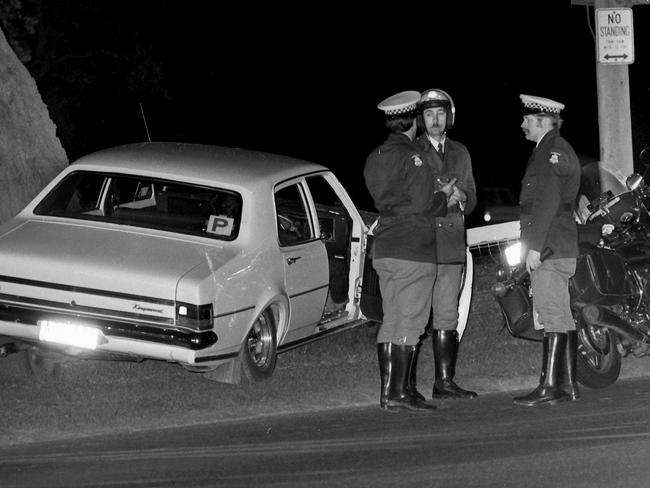 Police with Mr Cooper’s car on the night of the murder.