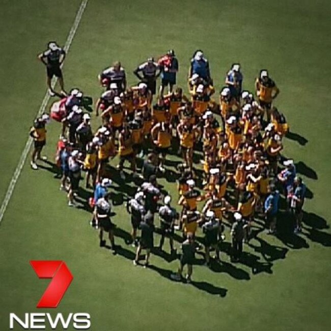 Hawthorn players gather in a huddle after Tom Mitchell was rushed to hospital. Picture: Channel 7