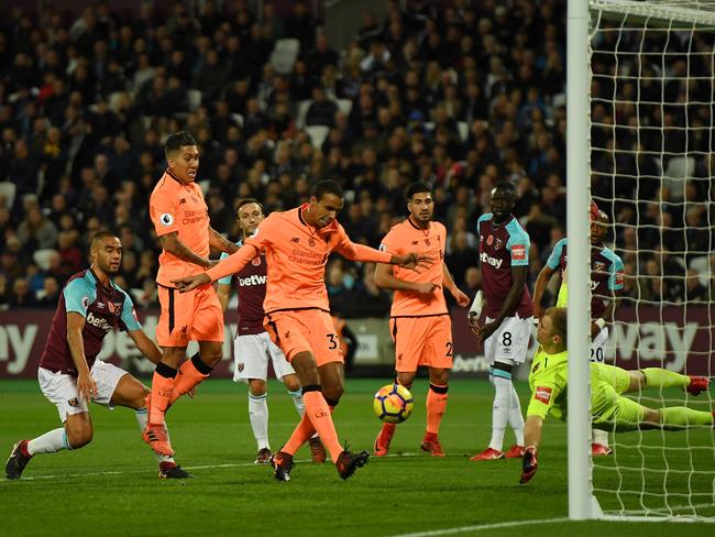 Joel Matip of Liverpool scores.